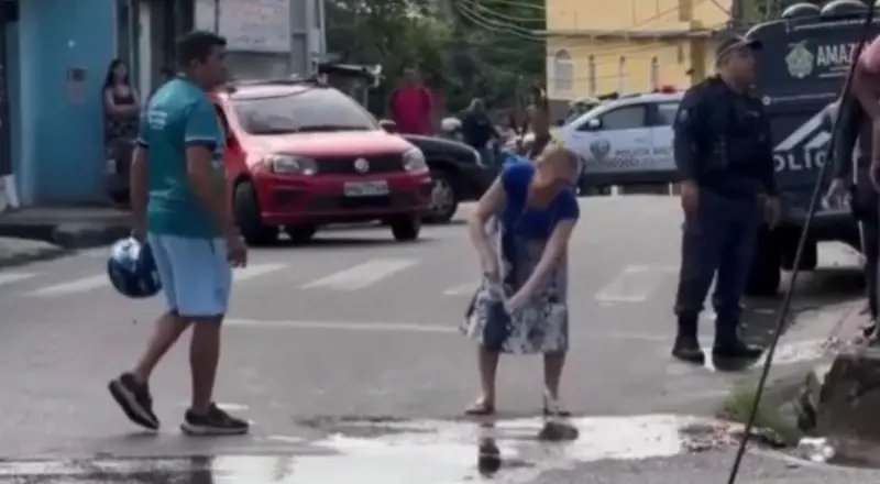 Idosa esfrega a rua para limpar o sangue do próprio filho que morreu em acidente em Manaus